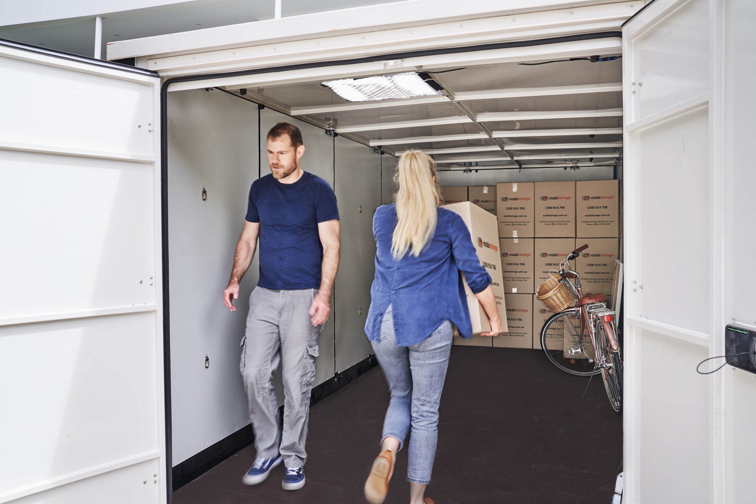 3-1056-0206 women and man walking in and out of mobile storage container