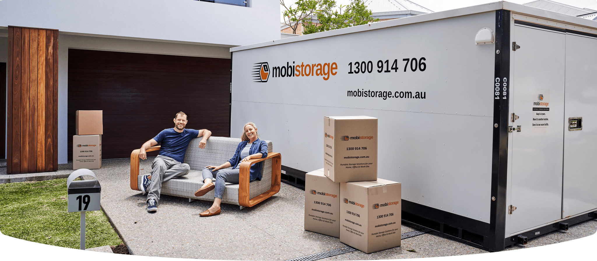 A couple about to load their storage boxes in the mobistorage container